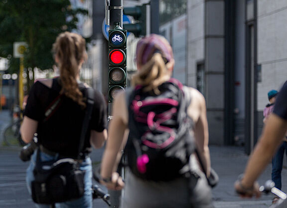 Radfahrende warten vor einer roten Ampel.