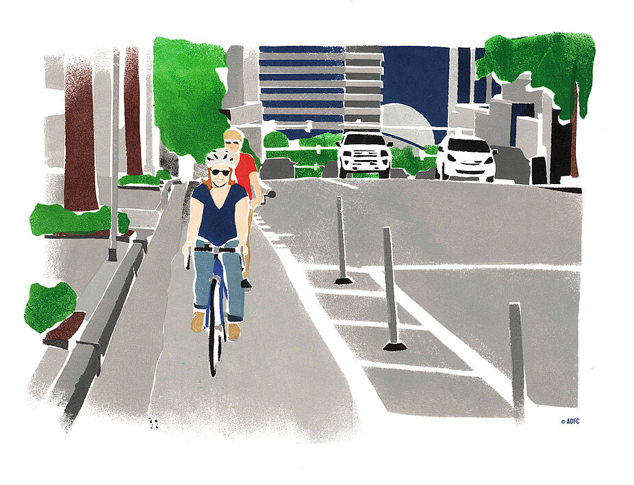 Protected Bikelane in den USA Mit Pollern und Sicherheitsstreifen geschützte Protected Bikelane in US-amerikanischer Stadt