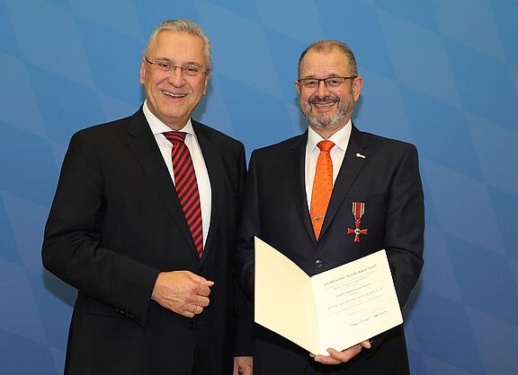 Der bayerische Innenminister Herrmann überreichte Armin Falkenhain das Verdienstkreuz am Bande des Verdienstordens der Bundesrepublik Deutschland.